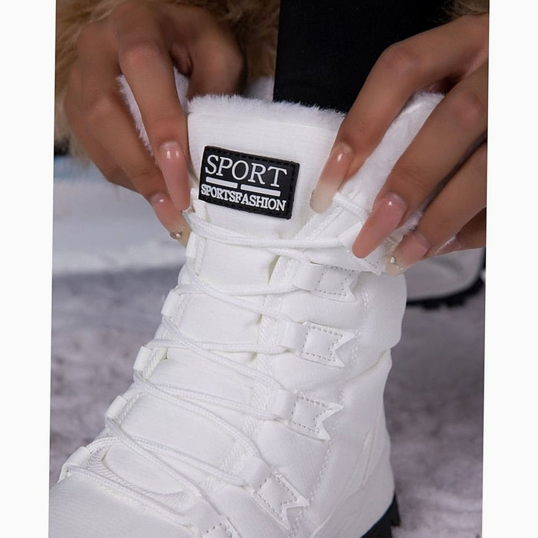 Close-up of Sport brand tag on plush white snow boot cuff