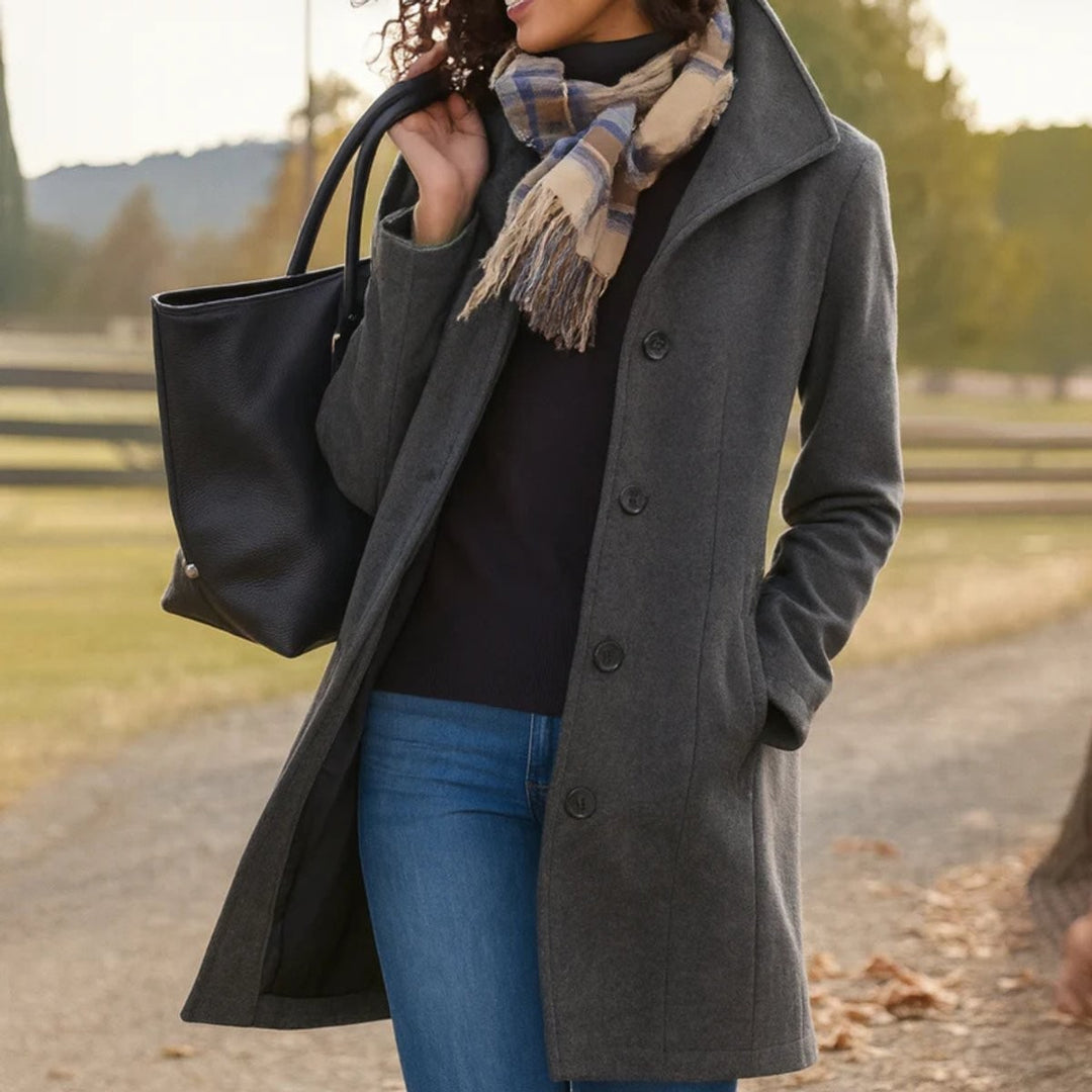 Charcoal gray mid-length wool-blend coat paired with jeans and black tote