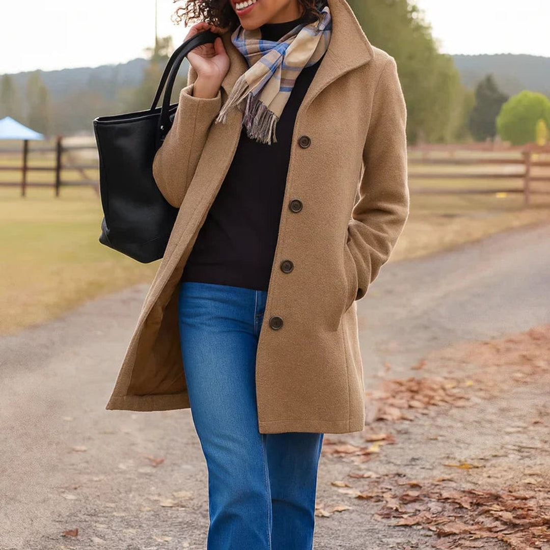 Camel wool-blend coat with notched collar worn over black turtleneck