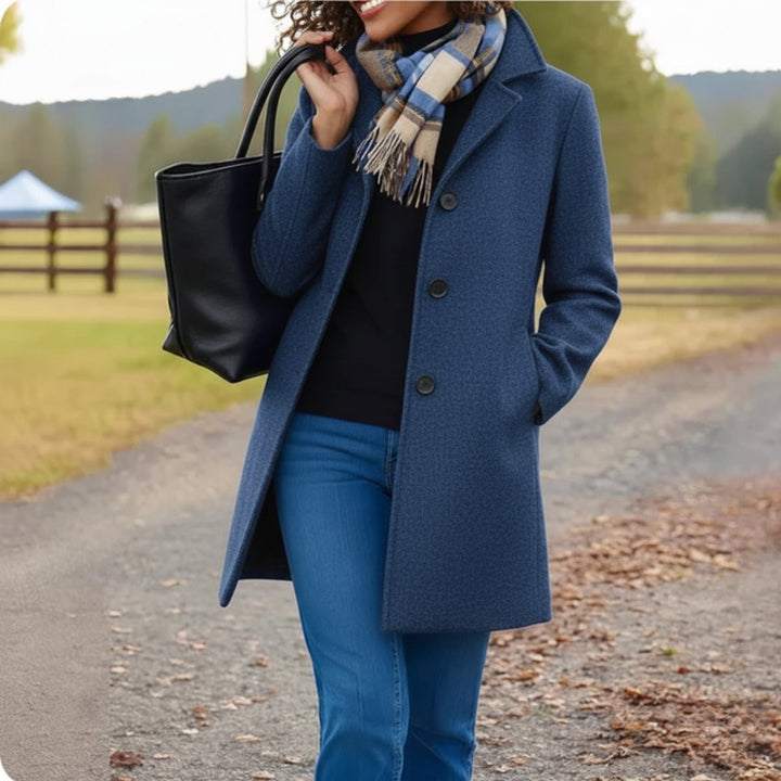Navy blue wool-blend coat with button front worn over black sweater