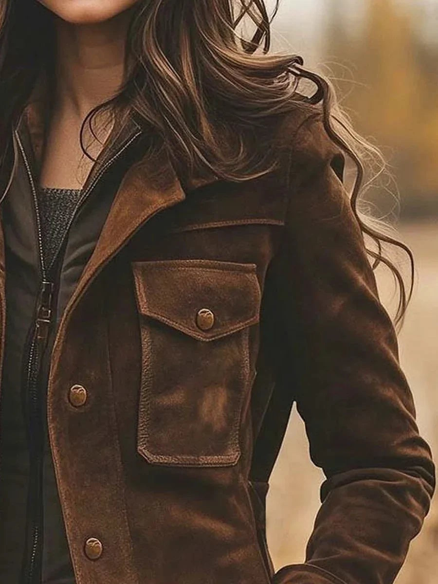 Close-up of brown suede jacket flap pocket and button front detailing