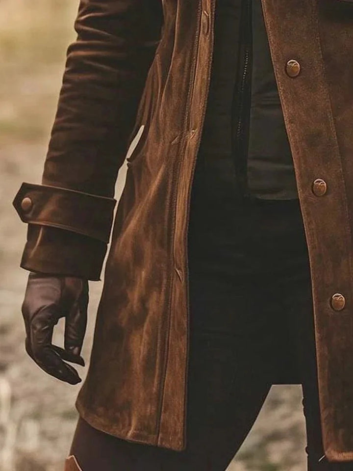 Side view of brown suede coat cuff with snap button and slit pocket