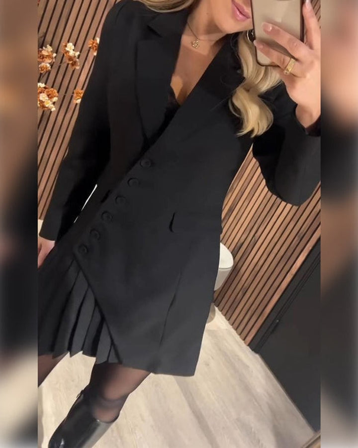 Close-up of black blazer dress showing button placket and pleats