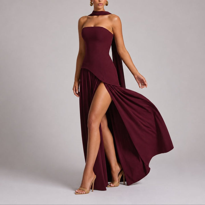 Burgundy strapless maxi dress with flowing scarf train and thigh-high slit