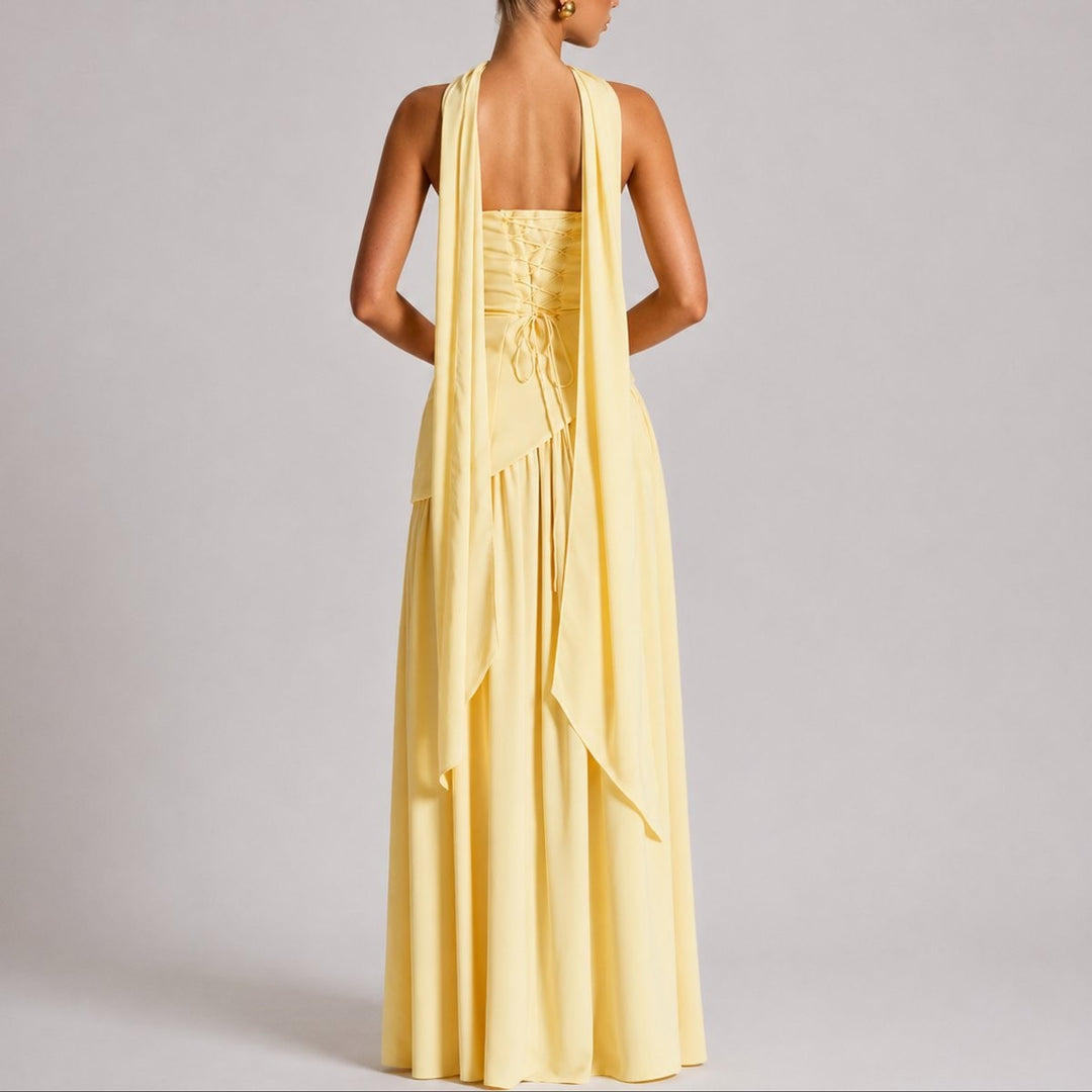Back view of yellow strapless gown showing lace-up corset and draped scarf straps
