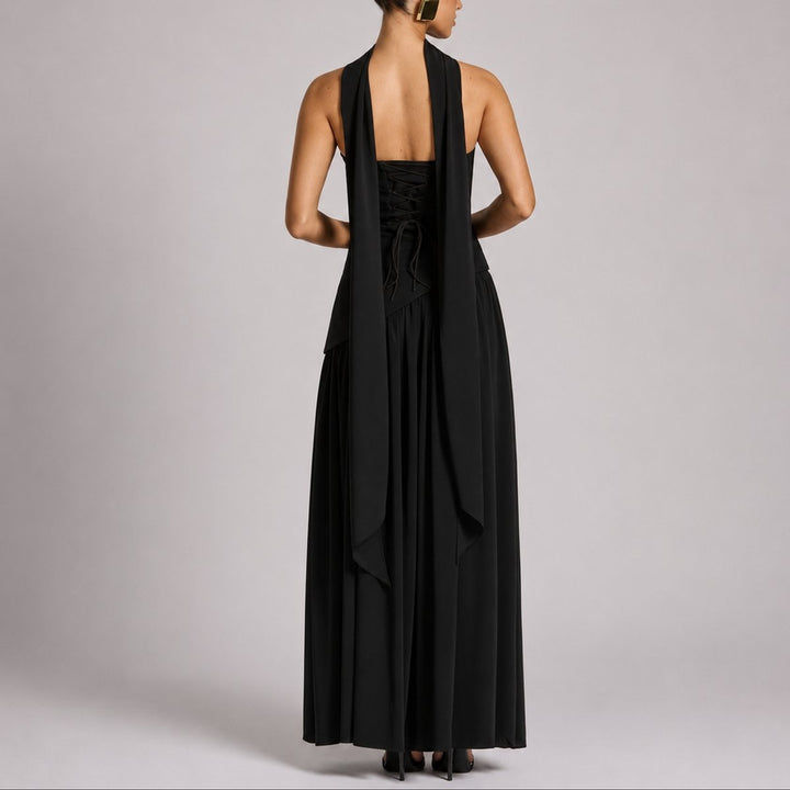 Back view of black maxi dress featuring halter scarf and corset lace-up detail