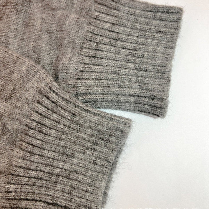 Close-up of ribbed knit cuffs on heather gray cardigan sleeves