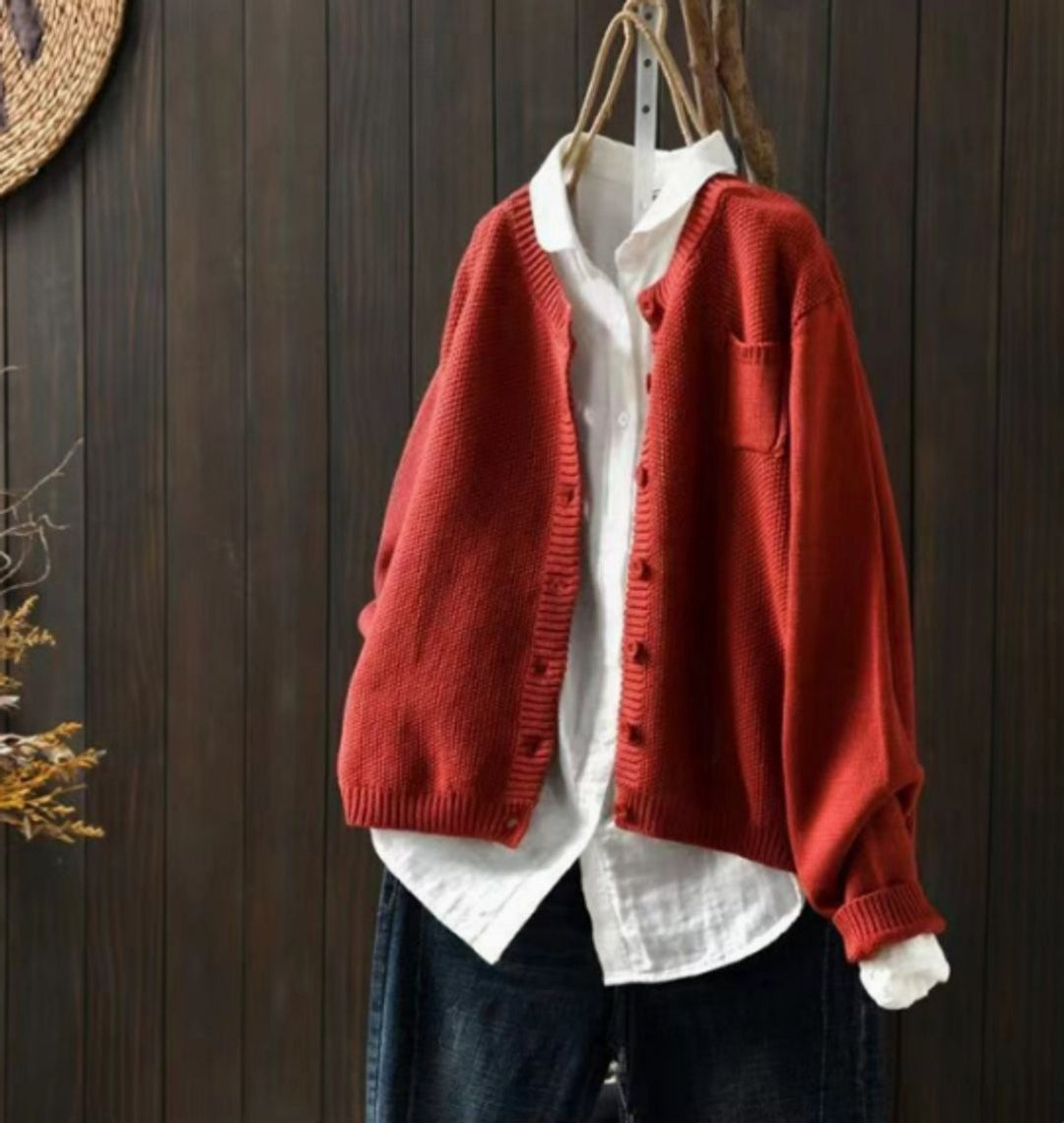Rust red oversized knit cardigan with button-front closure and chest pocket