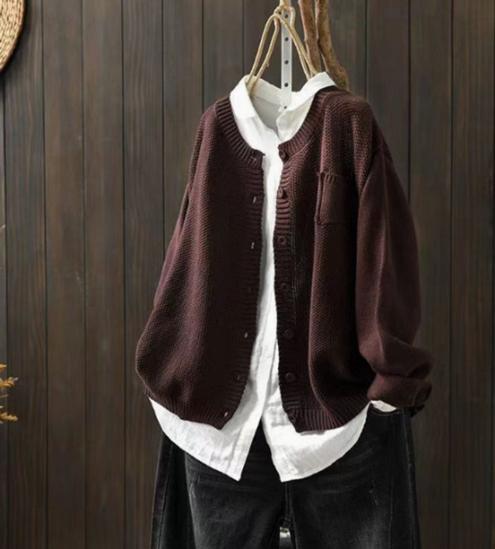 Dark brown chunky knit cardigan sweater layered over white collared shirt