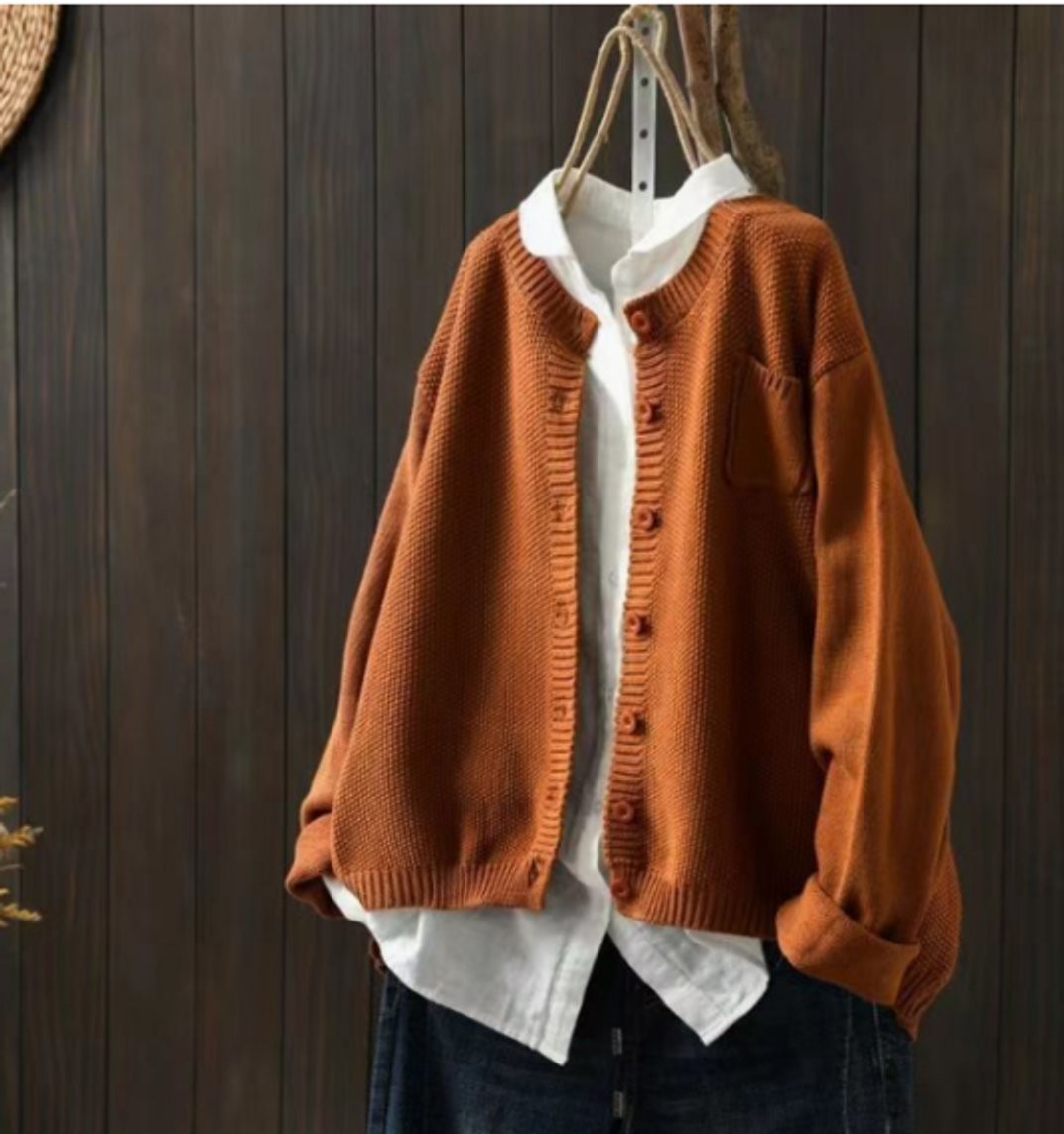 Burnt orange oversized cardigan sweater with wooden buttons and knit texture