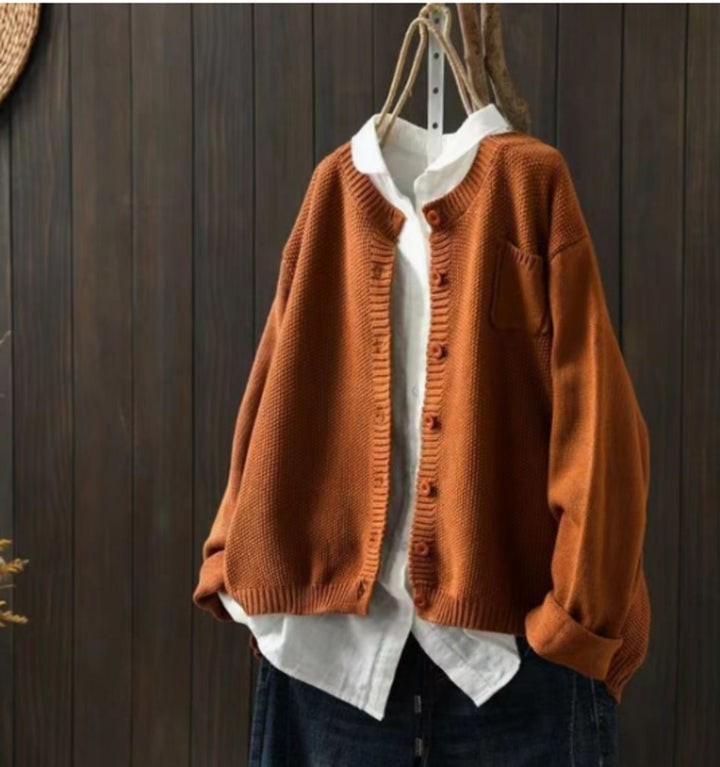 Burnt orange oversized cardigan sweater with wooden buttons and knit texture