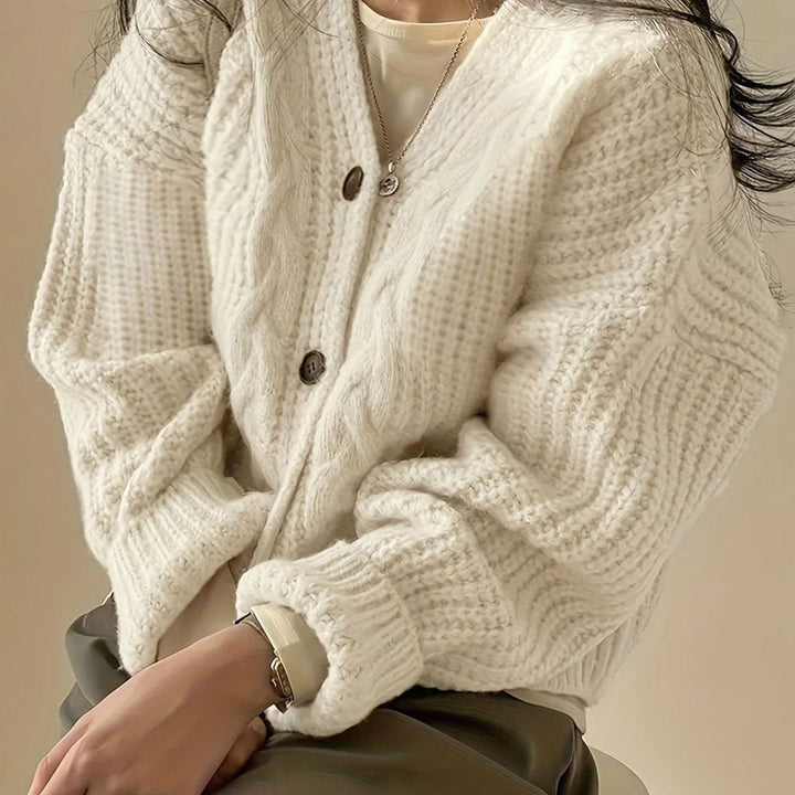 cream cable-knit button-front cardigan with chunky oversized sleeves close-up