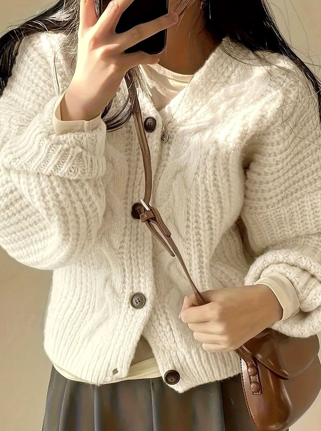 oversized ivory button-front cardigan paired with brown leather shoulder bag