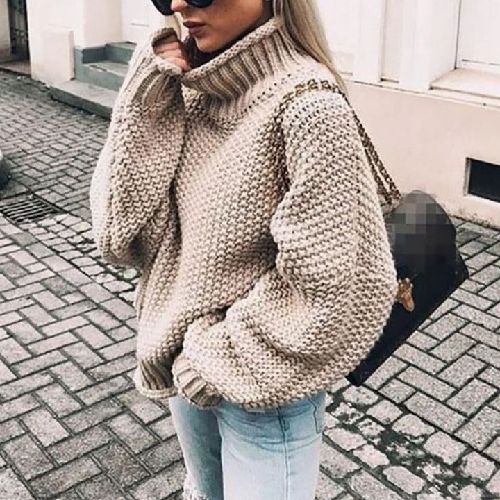 Beige oversized chunky knit turtleneck sweater with ribbed collar and balloon sleeves