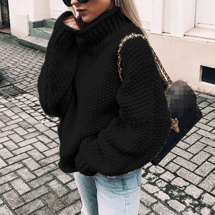 Black oversized chunky knit turtleneck sweater with ribbed neck and bishop sleeves