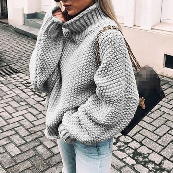 Gray oversized chunky knit turtleneck sweater styled with light wash jeans