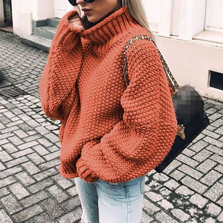Rust orange oversized chunky knit turtleneck sweater with textured purl stitch pattern