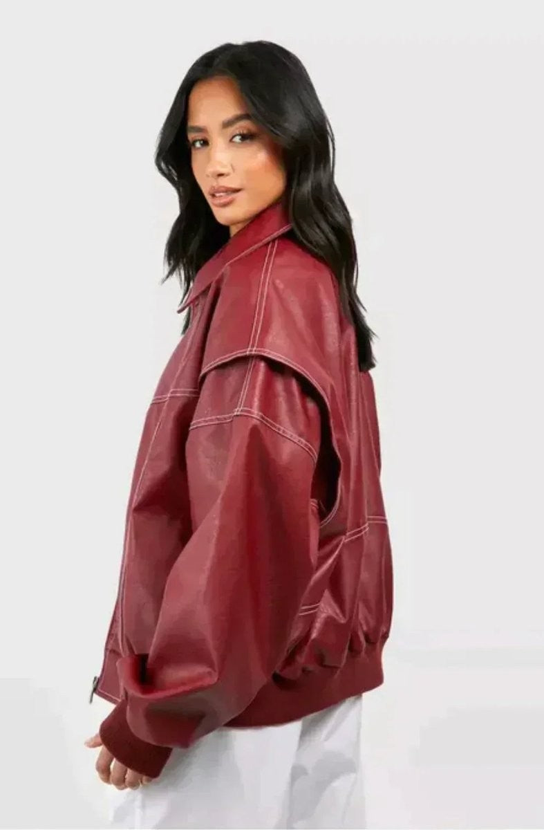 Side view of oxblood faux leather bomber jacket showing contrast stitch detail