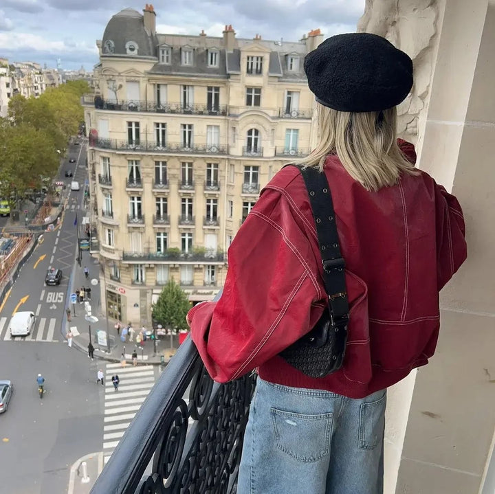 Back view of oversized red leather bomber jacket with crossbody bag detail