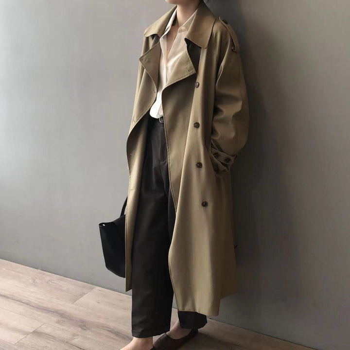 Khaki trench coat draped open, showing notched collar and button-front detail