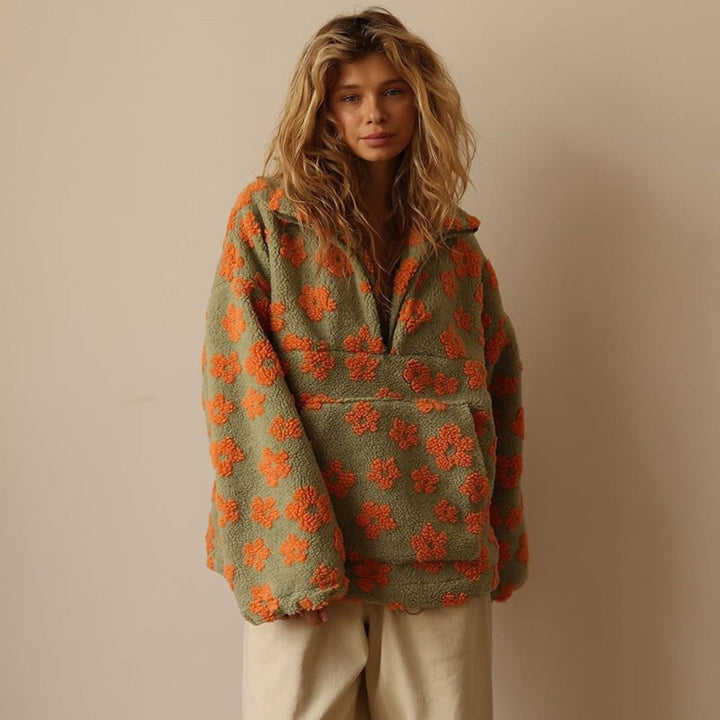 olive green sherpa half-zip pullover featuring bold orange floral pattern
