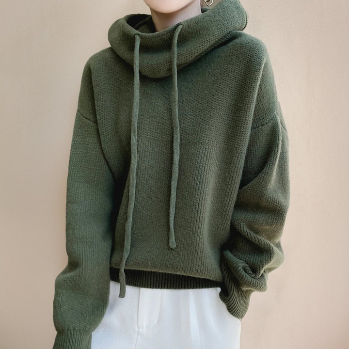 close-up of olive green merino wool hoodie with ribbed cuffs and hem