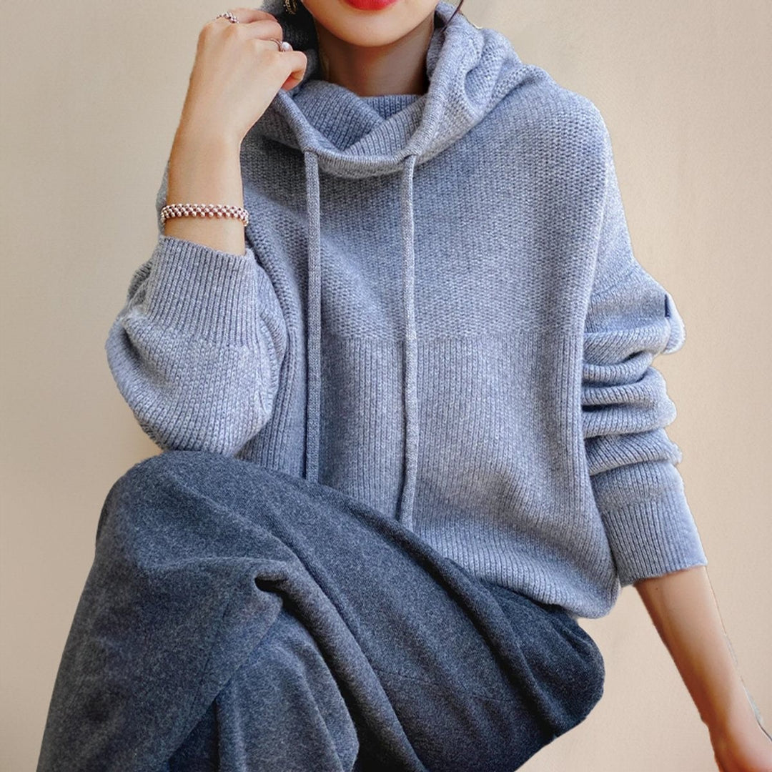 woman wearing gray oversized wool hoodie sweater with cowl neck and long sleeves
