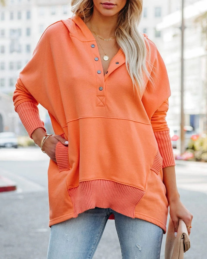 Coral hooded sweatshirt with snap-button neckline and ribbed pocket trim