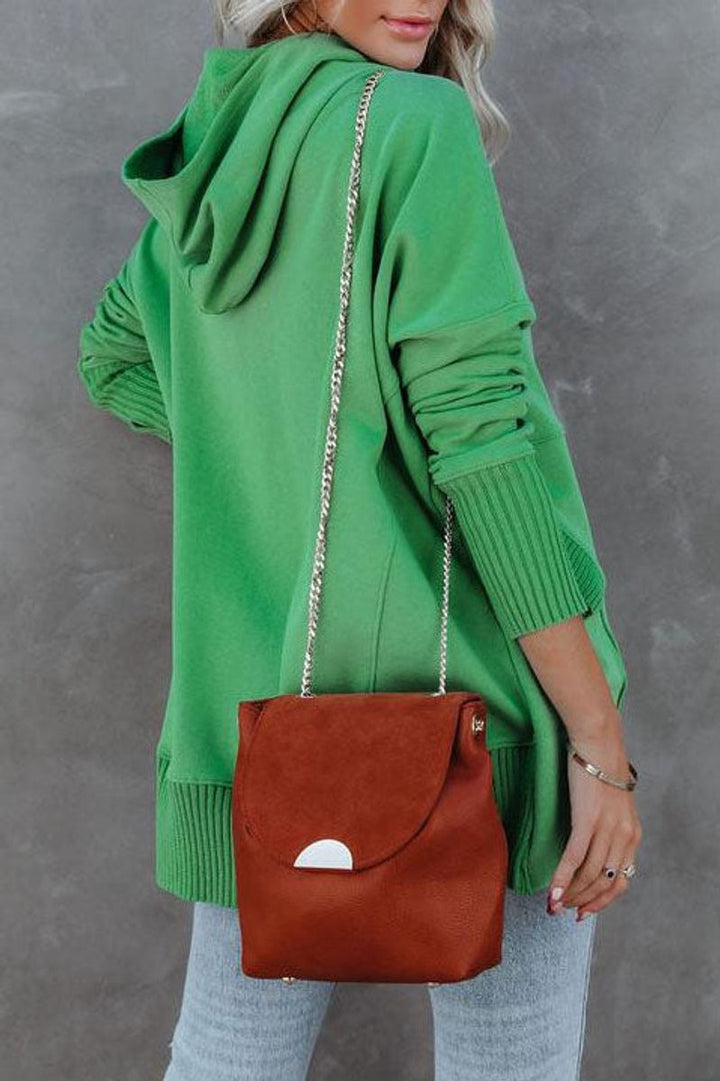 Back view of green oversized hoodie with hood and ribbed cuffs