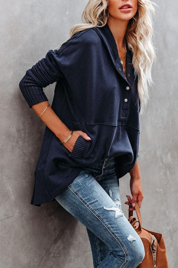 Navy oversized hoodie with snap neckline worn with distressed skinny jeans