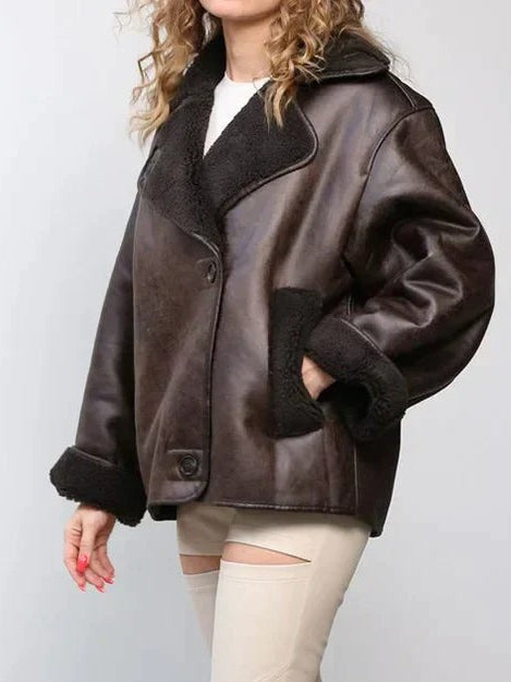 Dark brown leather jacket with shearling collar and cuffs, side view