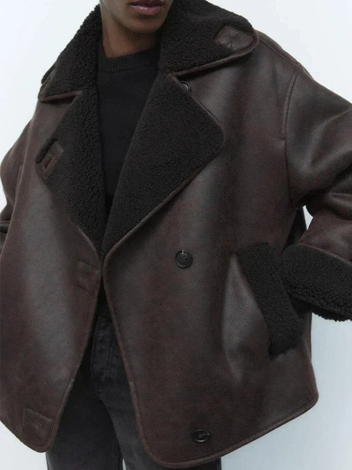Shearling-lined leather jacket collar and button closure, close-up view