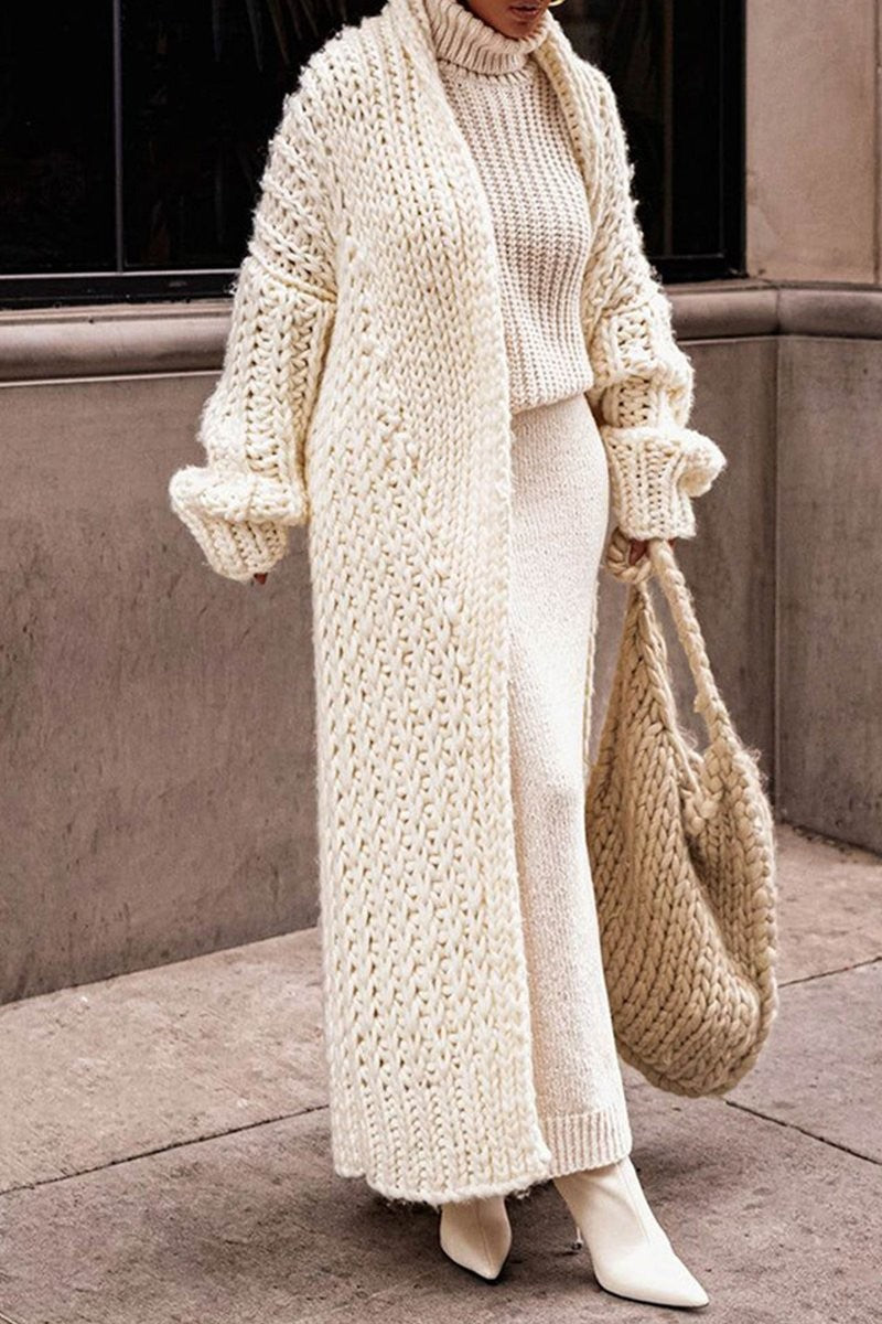 Cream chunky knit longline cardigan worn open over matching turtleneck sweater set