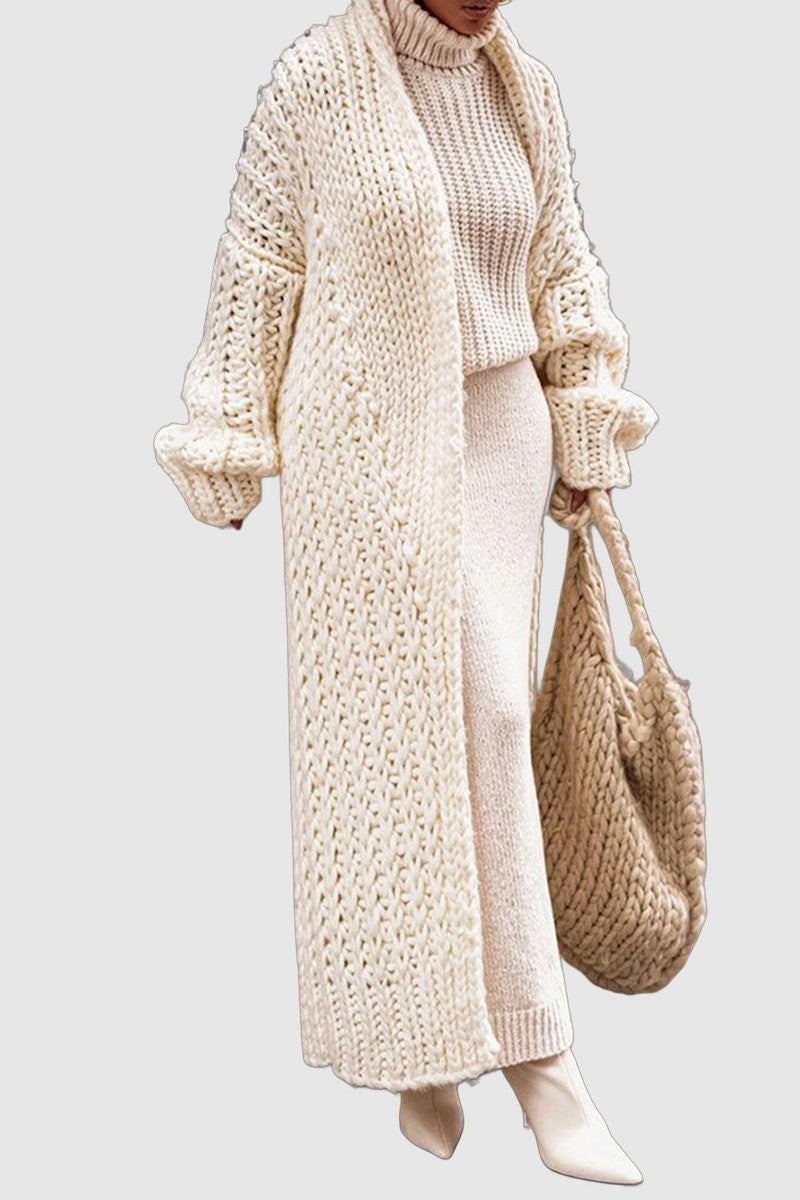 Ivory oversized cable-knit long cardigan styled with cream sweater and knit tote