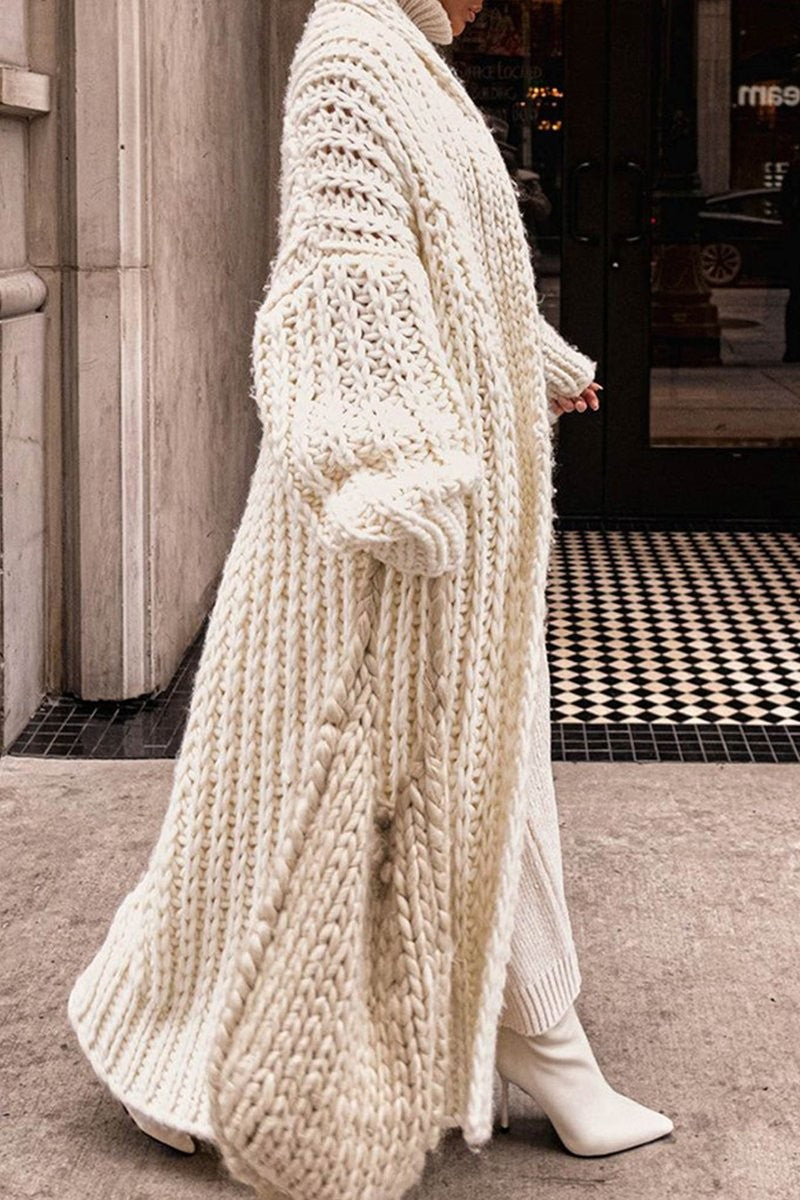 Side view of cream chunky knit longline cardigan showing cable-knit texture detail