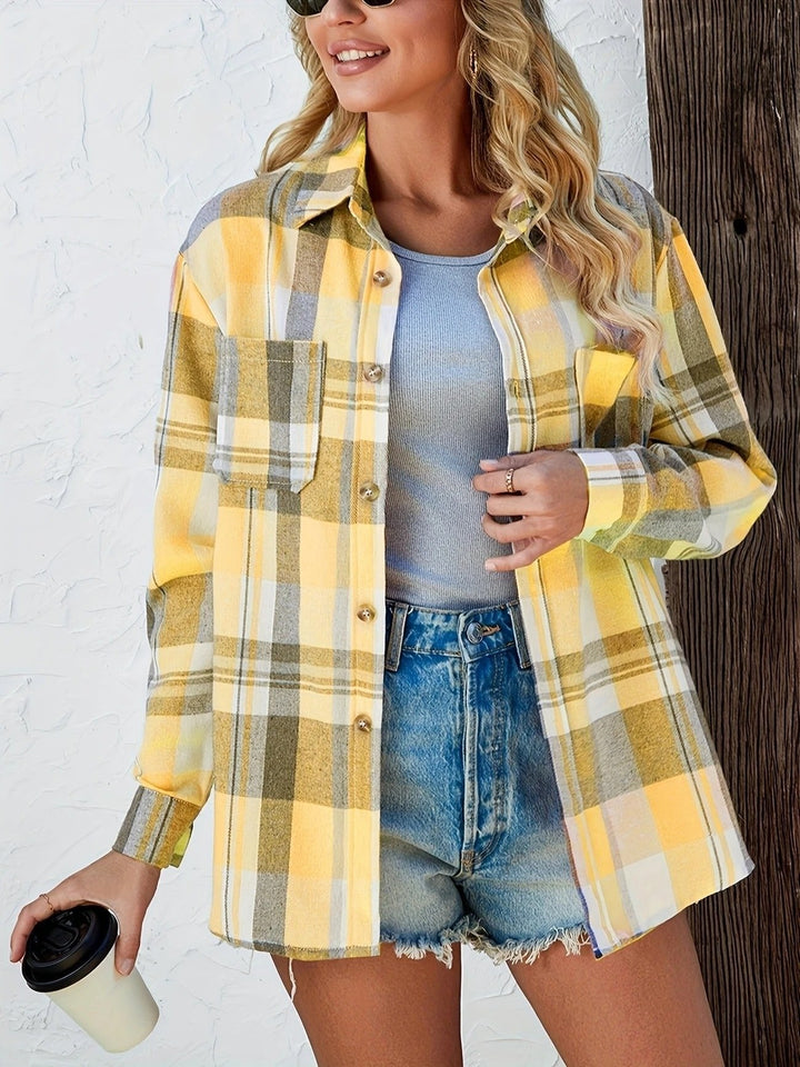 Yellow plaid oversized flannel shirt paired with distressed denim shorts, holding coffee