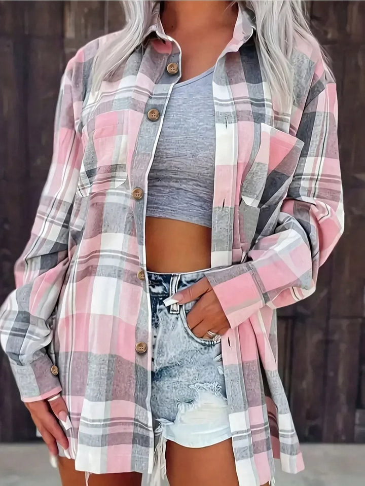 Close-up of pink and gray plaid flannel shirt with button-up front and pockets