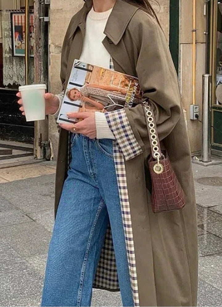 Olive trench coat with checkered lining and croc-textured shoulder bag