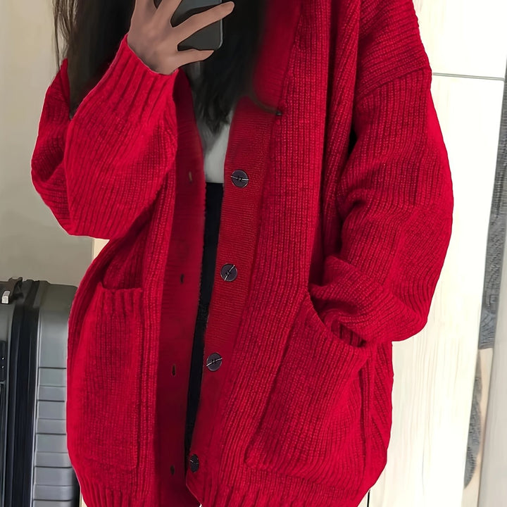 Red ribbed cardigan close-up highlighting knit texture and pockets