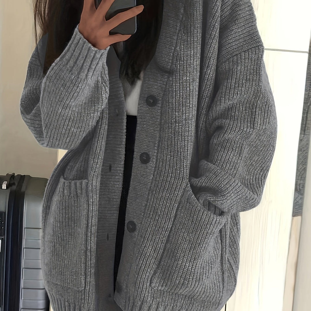 Gray ribbed cardigan close-up showing oversized sleeves and buttons