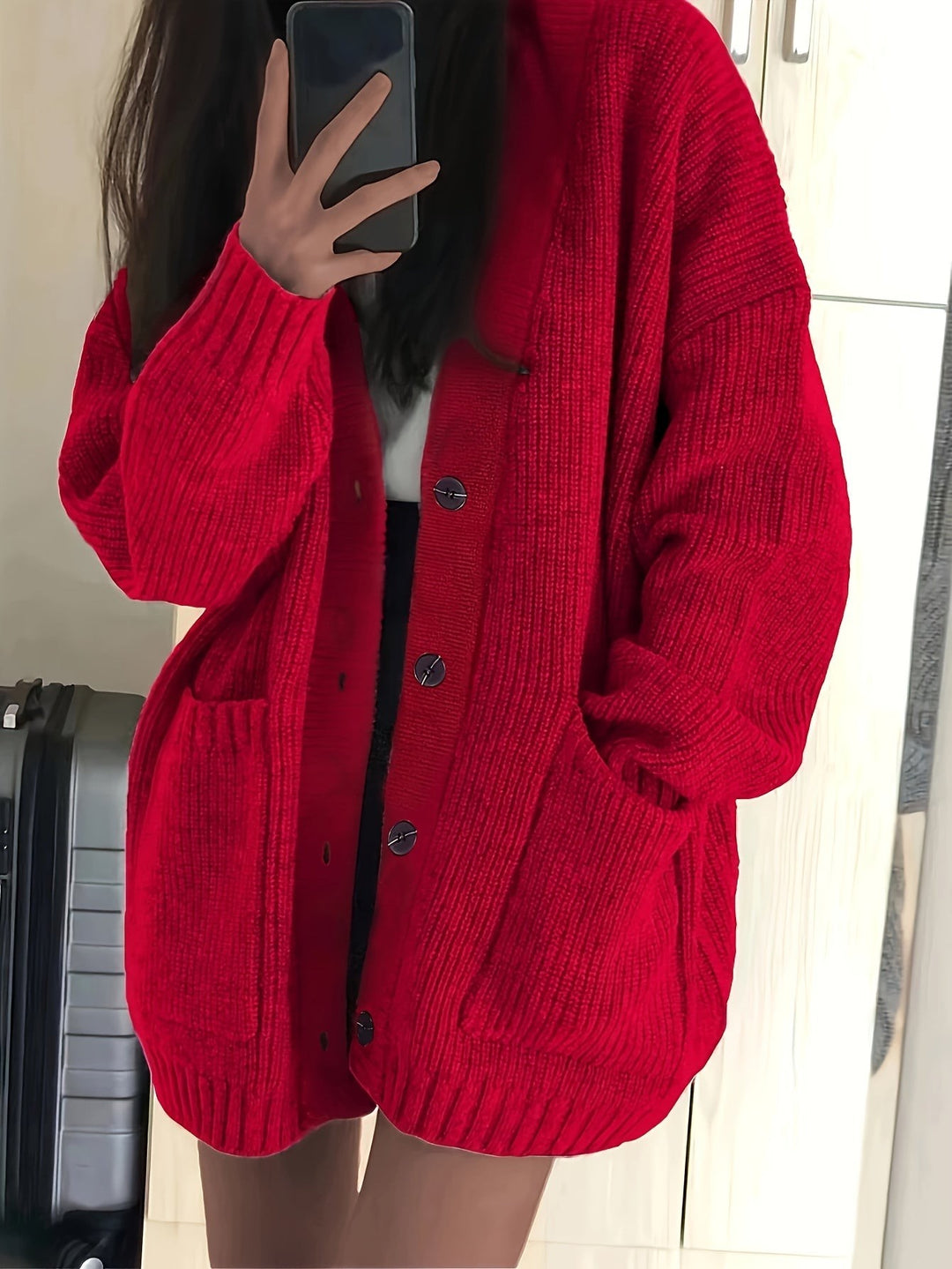 Red chunky knit cardigan featuring button closure and side pockets