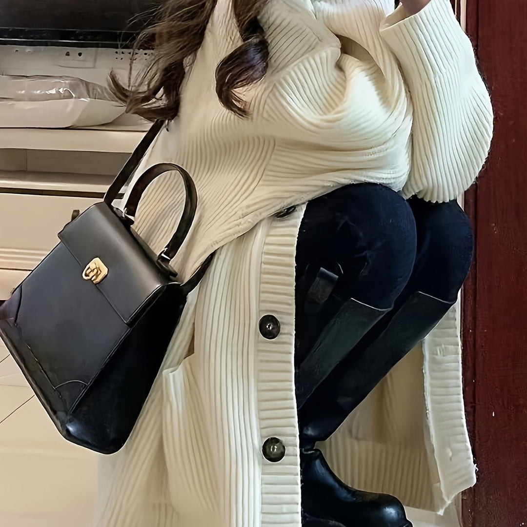 Cream long ribbed cardigan paired with a black leather handbag