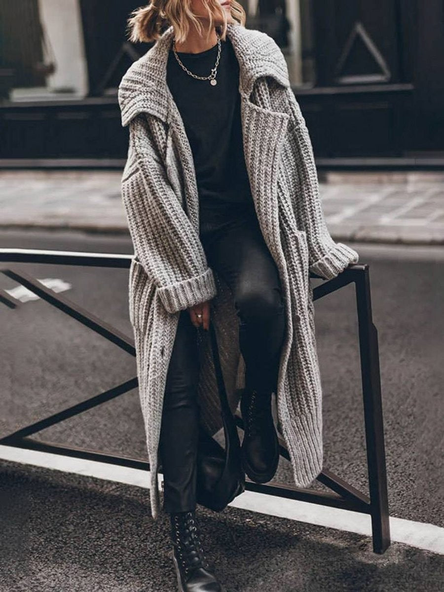 Gray chunky knit longline cardigan styled with black leggings and combat boots