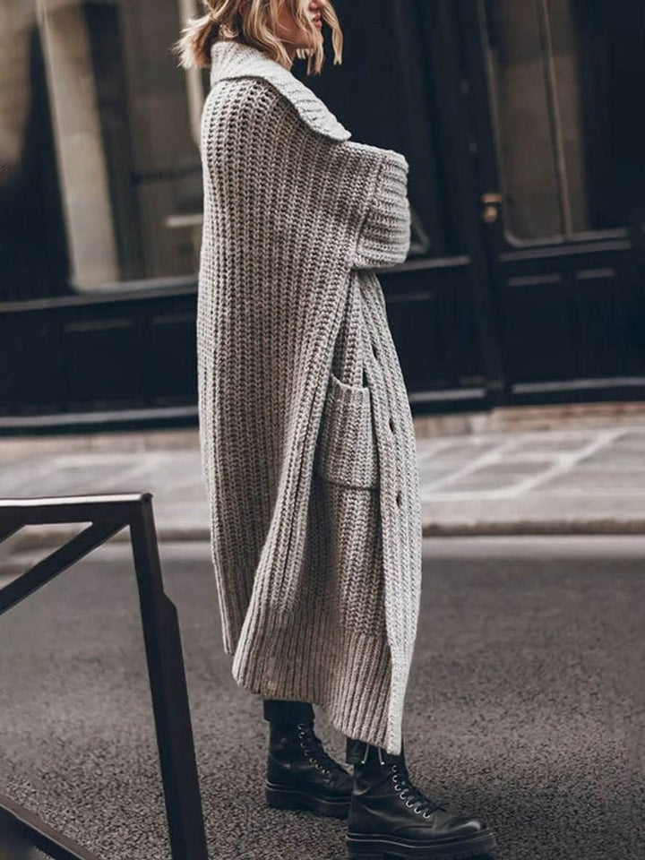 Side view of long gray ribbed knit cardigan with front pocket detail