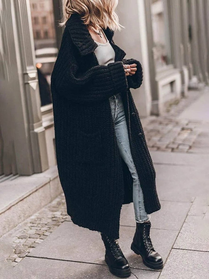 Black chunky knit longline cardigan paired with jeans and lace-up boots