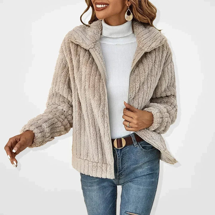 Beige textured faux fur zip-up jacket with collared lapel and ribbed cuffs