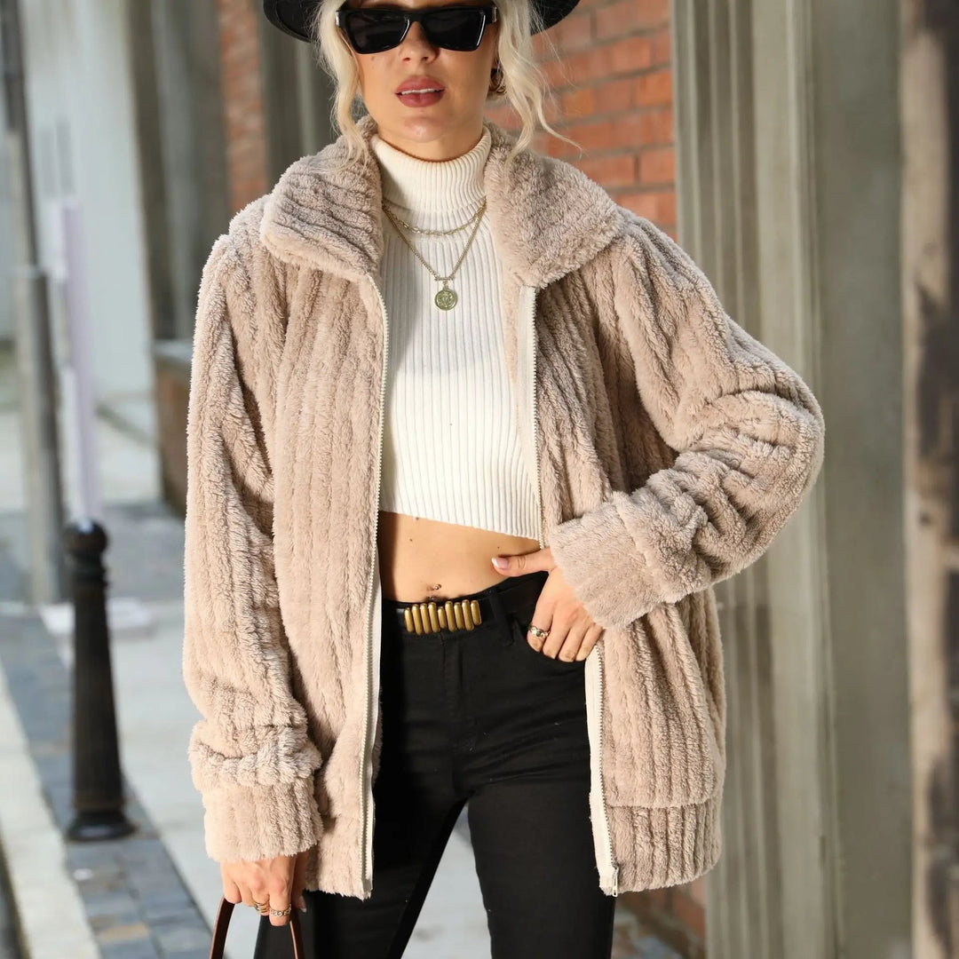 Close-up of oversized taupe faux fur coat with textured ribbed sleeves