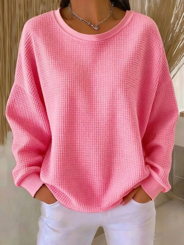 Blush pink waffle-knit pullover sweater with round neckline and oversized fit