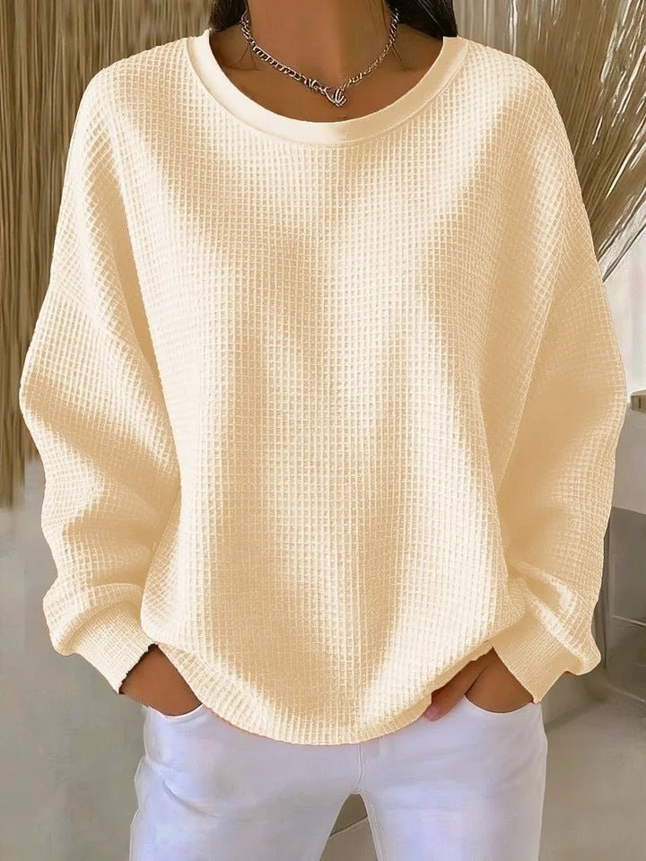 Cream waffle-knit oversized sweater with round neck and long sleeves