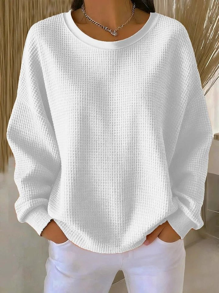 White waffle-knit oversized pullover sweater with round neckline and ribbed hem